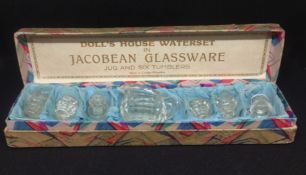 A boxed dolls house water set in Jacobean glass ware (7).