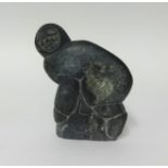 A 1970's signed Inuit carved figure of a Crouching Hunter by Levi Amidlak (1931-1998), height
