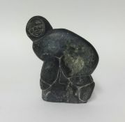 A 1970's signed Inuit carved figure of a Crouching Hunter by Levi Amidlak (1931-1998), height