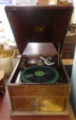 A vintage HMV wind up table top and mahogany cased gramophone.