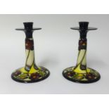 Moorcroft, a pair of candlesticks, 'The Dames Pansy', 850/9 by P.Harrison.