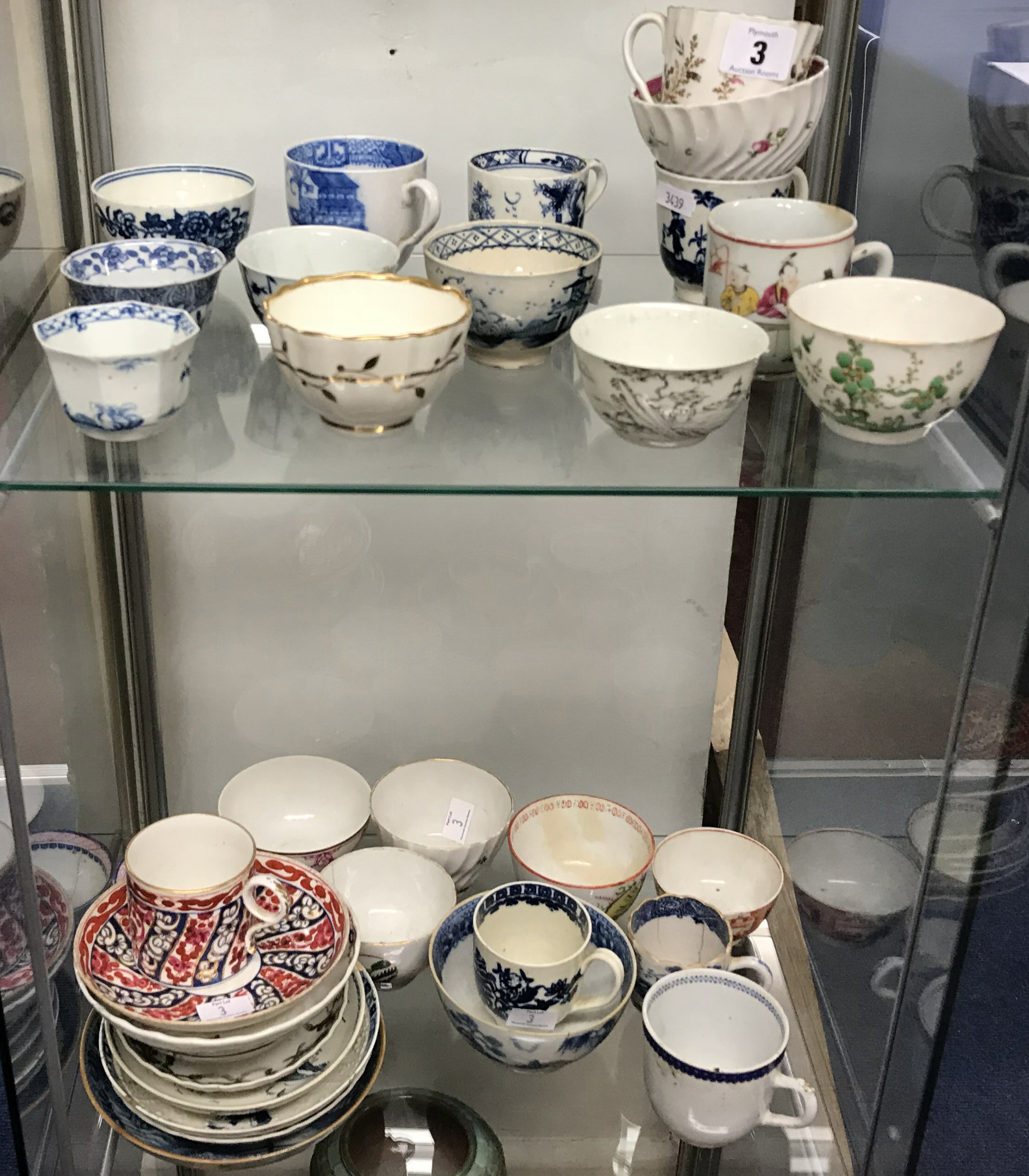A collection of antique porcelain tea bowls and some saucers, English and Oriental, approx 25.