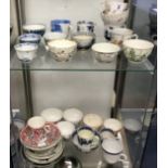 A collection of antique porcelain tea bowls and some saucers, English and Oriental, approx 25.