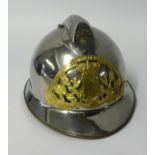 A vintage Fireman's helmet in steel and pierced brass.