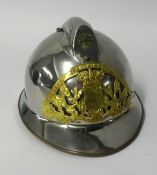 A vintage Fireman's helmet in steel and pierced brass.