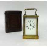 A French brass cased carriage clock with platform escapement, key and travel box.