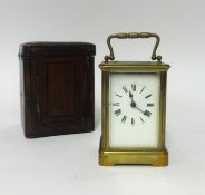 A French brass cased carriage clock with platform escapement, key and travel box.