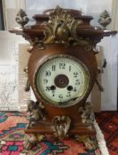 A French mahogany cased clock with ornate gilt decoration including cherub finial, movement detached