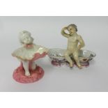 A 19th Century porcelain figure of a cherub with baskets, of Meissen style, cross swords mark to