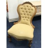 A Victorian walnut framed nursing chair with button back upholstery and cabriole legs, together with