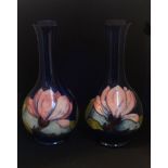 A pair of William Moorcroft bottle vases, magnolia, signed in green, impress marks, height 22cm.