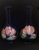 A pair of William Moorcroft bottle vases, magnolia, signed in green, impress marks, height 22cm.