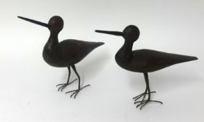 A pair of primitive carved wood standing birds, height 22cm.