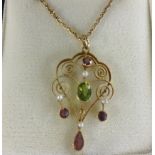 An antique 15ct gold peridot, pink tourmaline and pearl scrolled wire pendant and chain, circa 1900,
