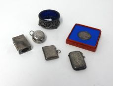 A round silver sovereign holder, two silver vestas, a silver match case, a silver and blue glass