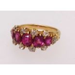 A fine five stone ruby and diamond ring set in yellow gold, finger size O.