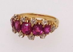 A fine five stone ruby and diamond ring set in yellow gold, finger size O.