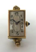 A vintage ladies 9ct gold rectangular wristwatch with jewelled crown, the back plate stamped '