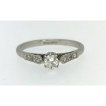 A platinum and diamond set solitaire ring.