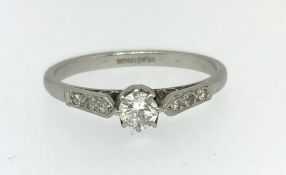 A platinum and diamond set solitaire ring.
