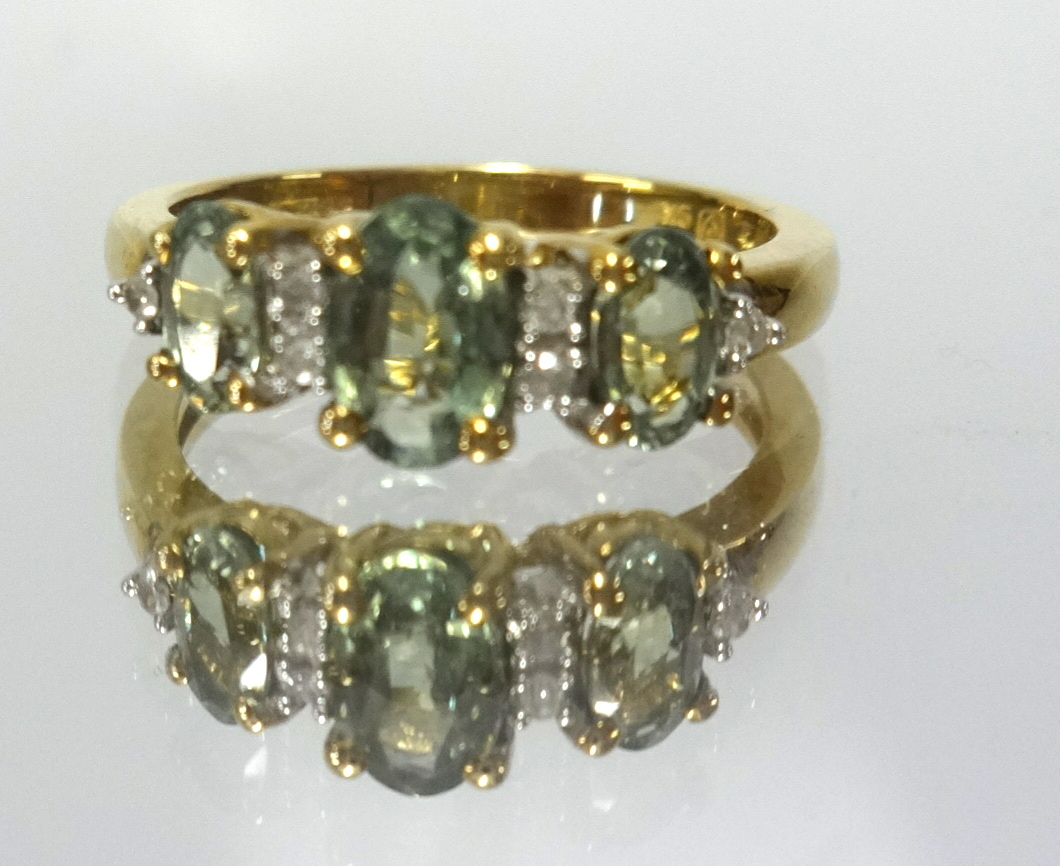 A 9ct tourmaline and diamond dress ring stamped 9K, finger size K.