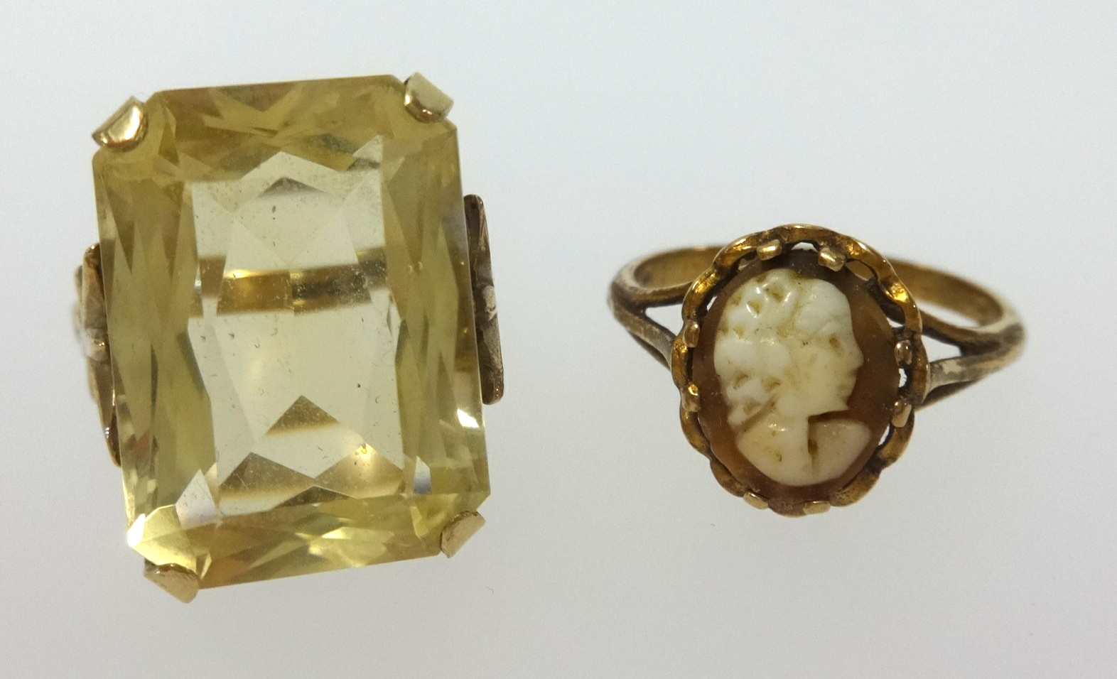 A 9ct citrine set ring, finger size K, and a 9ct cameo set ring (2).