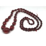 A red amber faceted bead necklace.