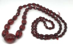A red amber faceted bead necklace.