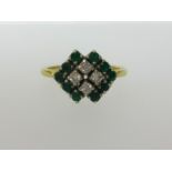 An 18ct emerald and diamond ring, finger size L.