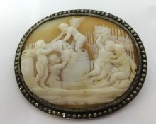 A cameo brooch with marcasite style border.