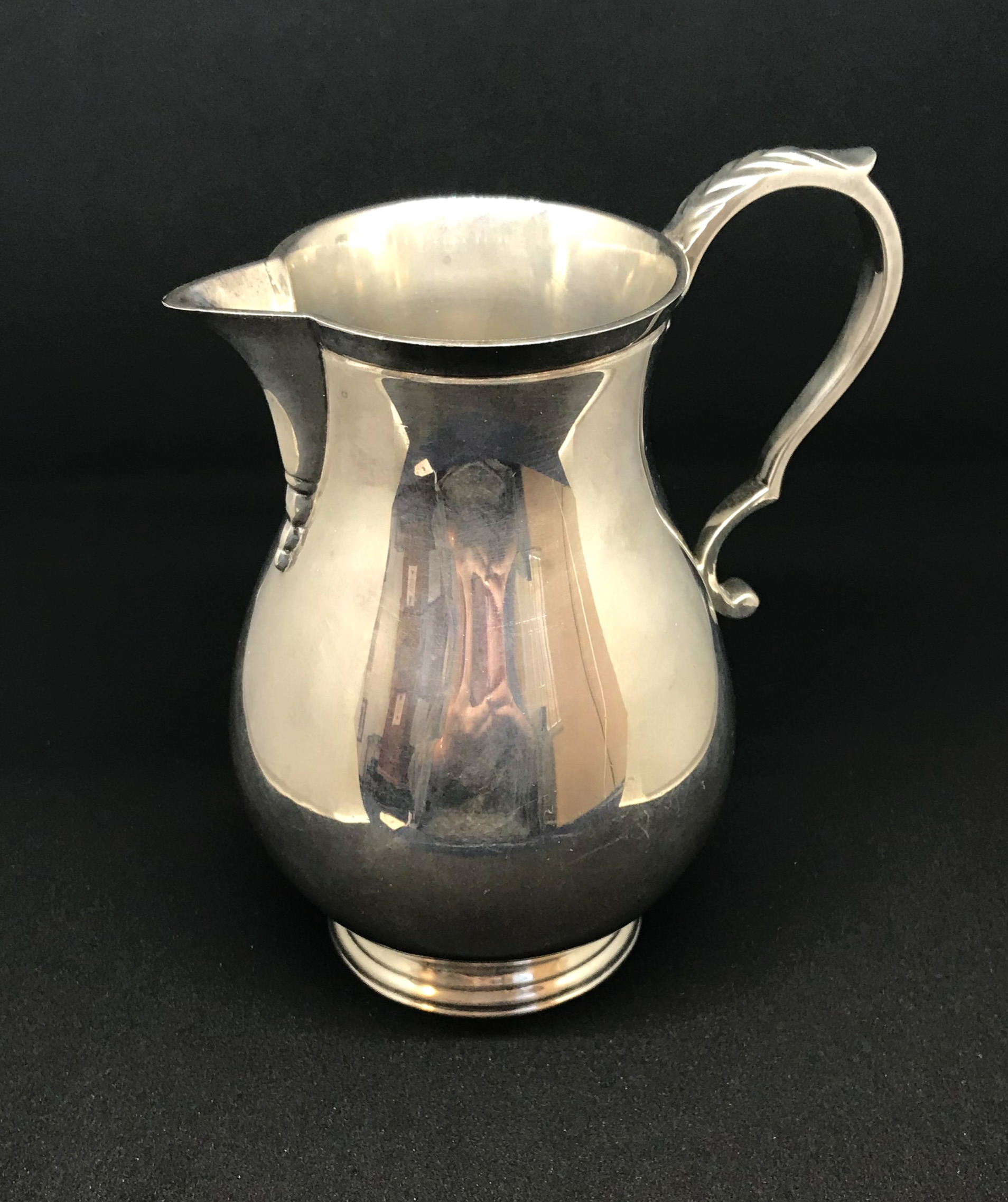 A modern heavy gauge silver and baluster shape jug, marked Goldsmiths and Silversmiths, approx 11.