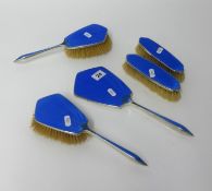 A five piece silver and blue enamelled back dressing table set.