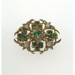 An antique emerald and diamond brooch.