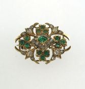 An antique emerald and diamond brooch.
