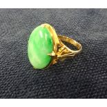 A 22ct gold large oval jade ring, finger size Q.