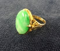 A 22ct gold large oval jade ring, finger size Q.