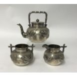 Chinese Export Silver, a three piece tea service comprising teapot, sugar bowl and cream jug, each