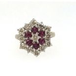 A fine ruby and diamond target ring set in yellow gold, unmarked, finger size O/P.