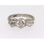 An 18ct white gold diamond three stone ring, finger size I.