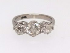 An 18ct white gold diamond three stone ring, finger size I.