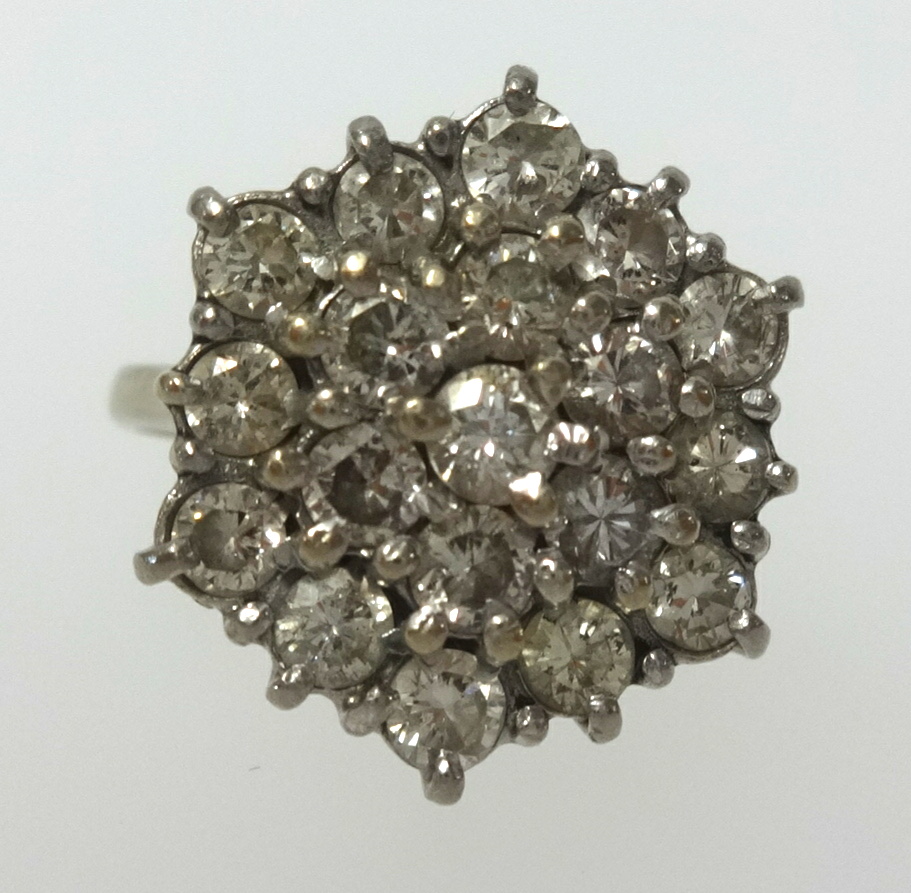 An 18ct white gold diamond cluster ring of tiered style, finger size L.