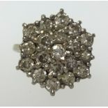 An 18ct white gold diamond cluster ring of tiered style, finger size L.
