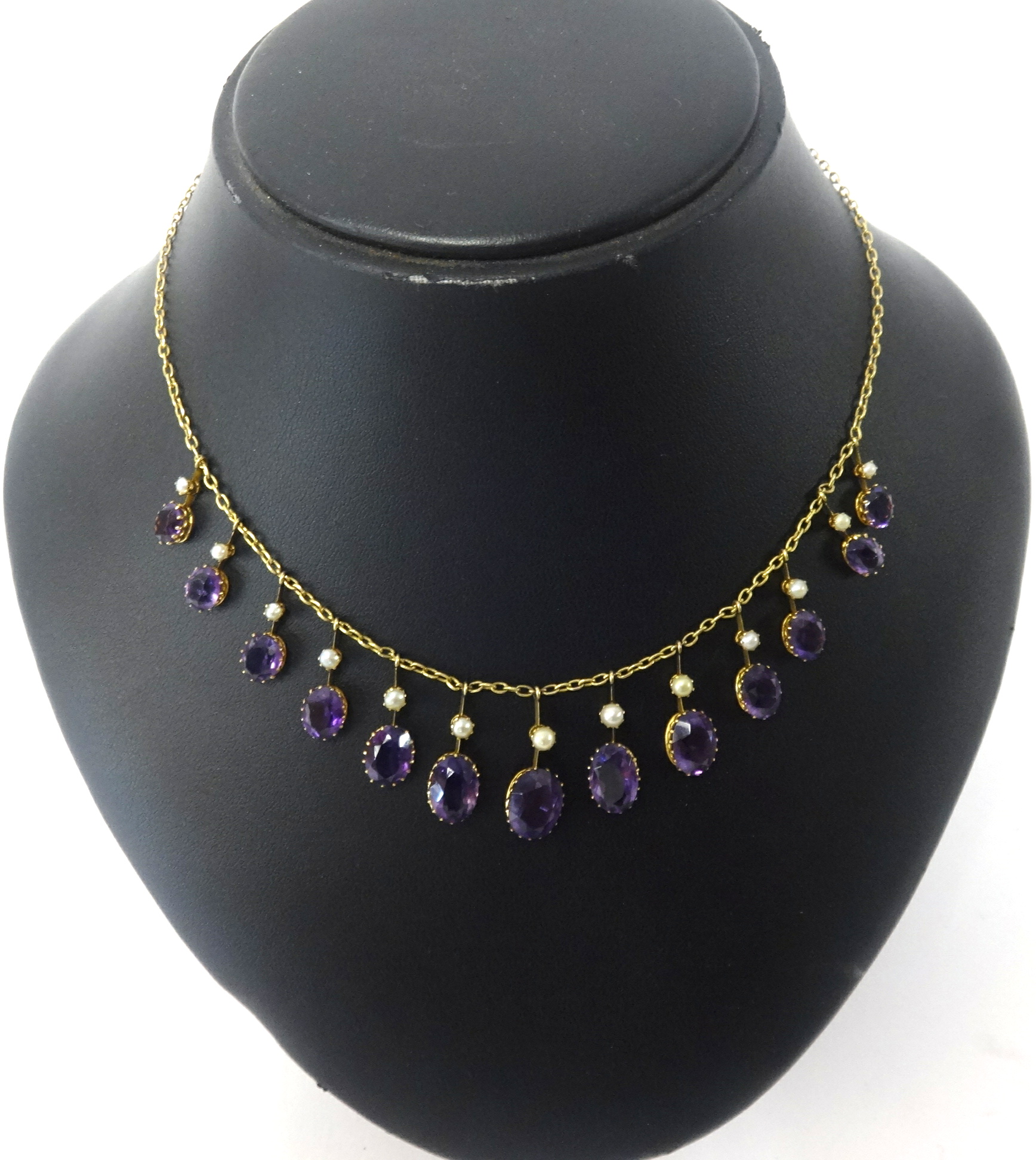 A 9ct gold fringe necklace set with amethyst and pearl.