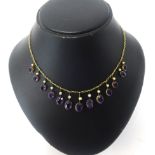 A 9ct gold fringe necklace set with amethyst and pearl.