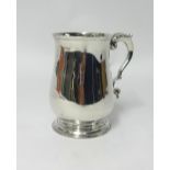 A George III silver and baluster shaped tankard with acanthus decorated scroll handle, underside