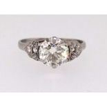 A fine diamond ring set with a good centre stone of approx 1.75cts with further diamonds to the