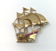 An 18ct ruby and diamond galleon brooch.