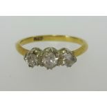 An 18ct small three stone diamond ring, finger size L.