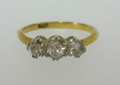 An 18ct small three stone diamond ring, finger size L.