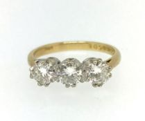 An 18ct three stone diamond ring, approx 1.50ct, finger size O.